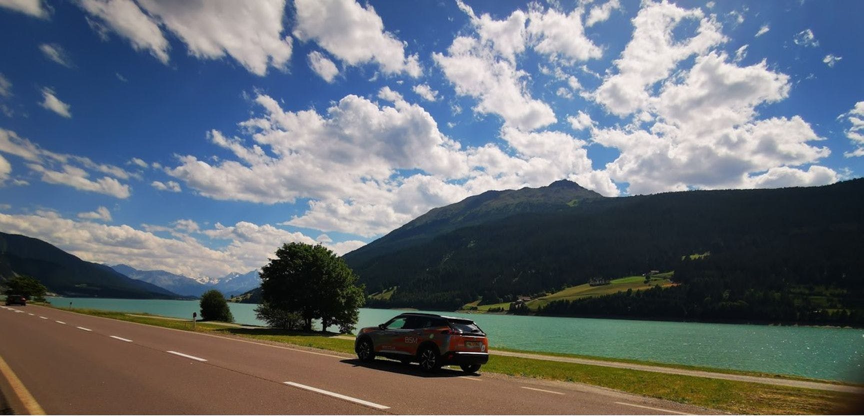 Photograph of an EV driving along the French-Swiss border