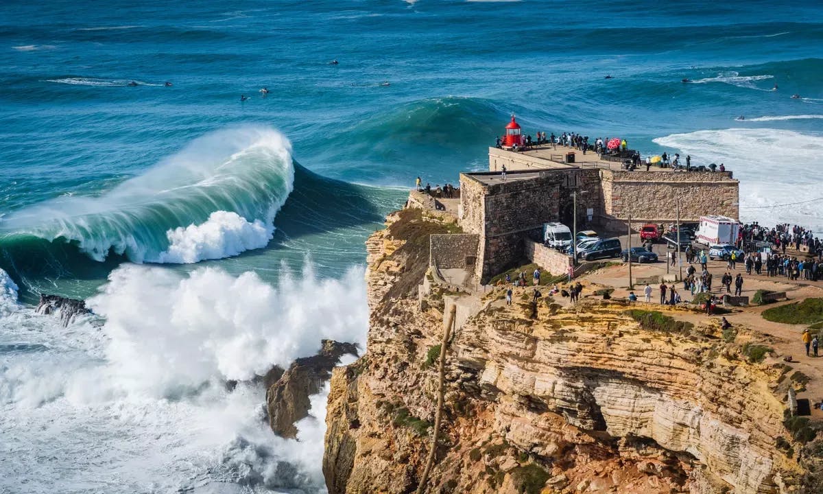 Huge waves crashing near the Fort of Nazaré lighthouse