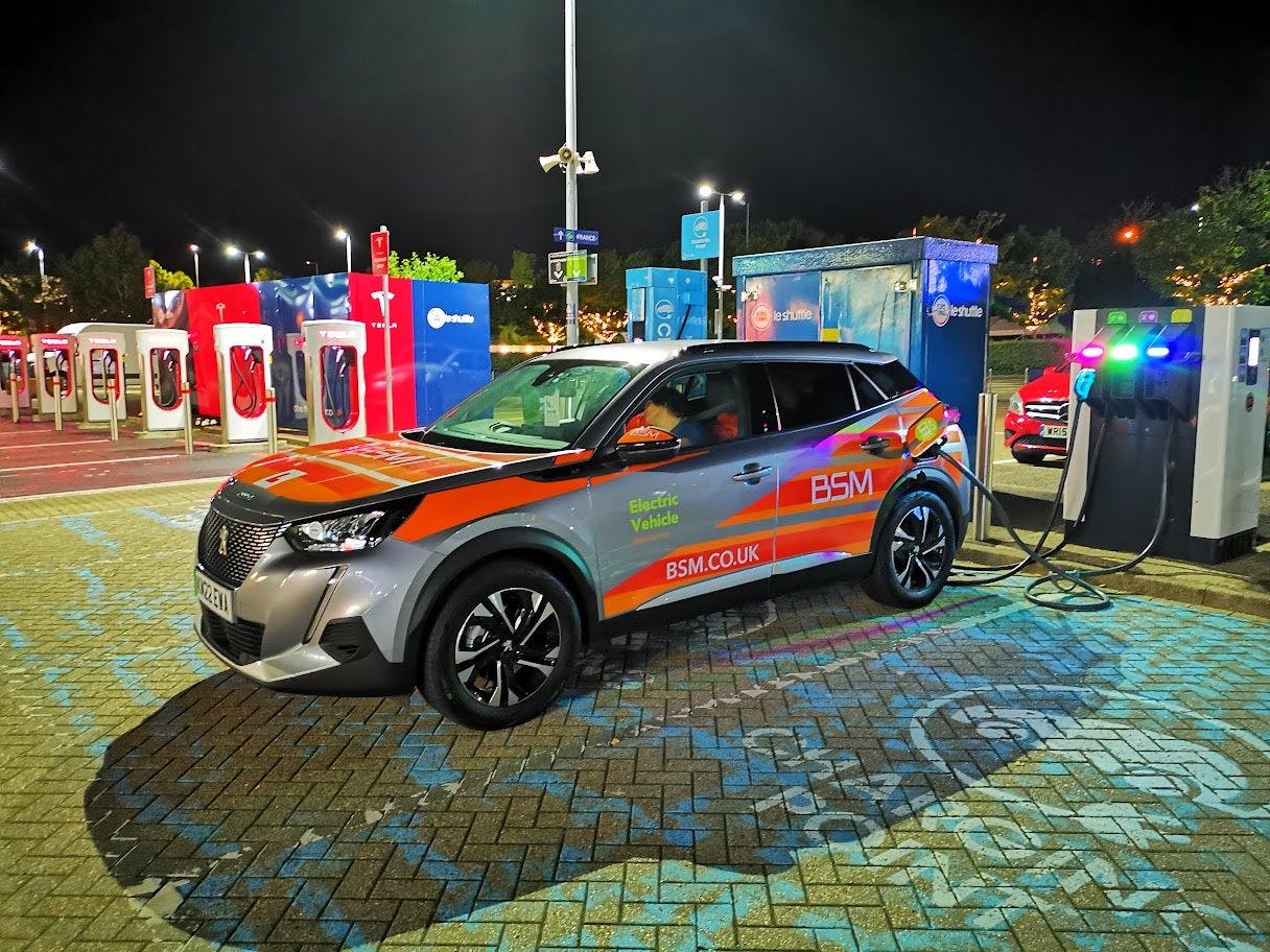 Photograph of peugeot e-208 charging at rapid charging station in Folkestone