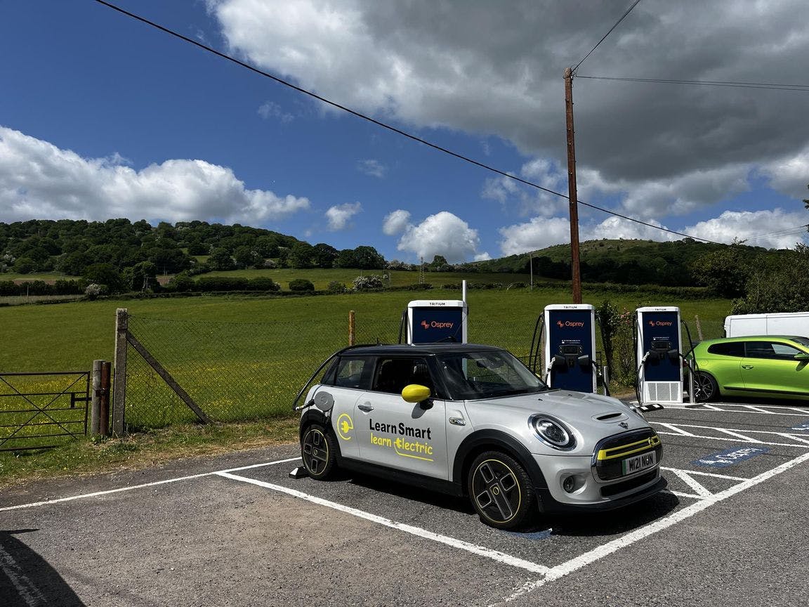 electric mini cooper charging at osprey charging station in sunny weather