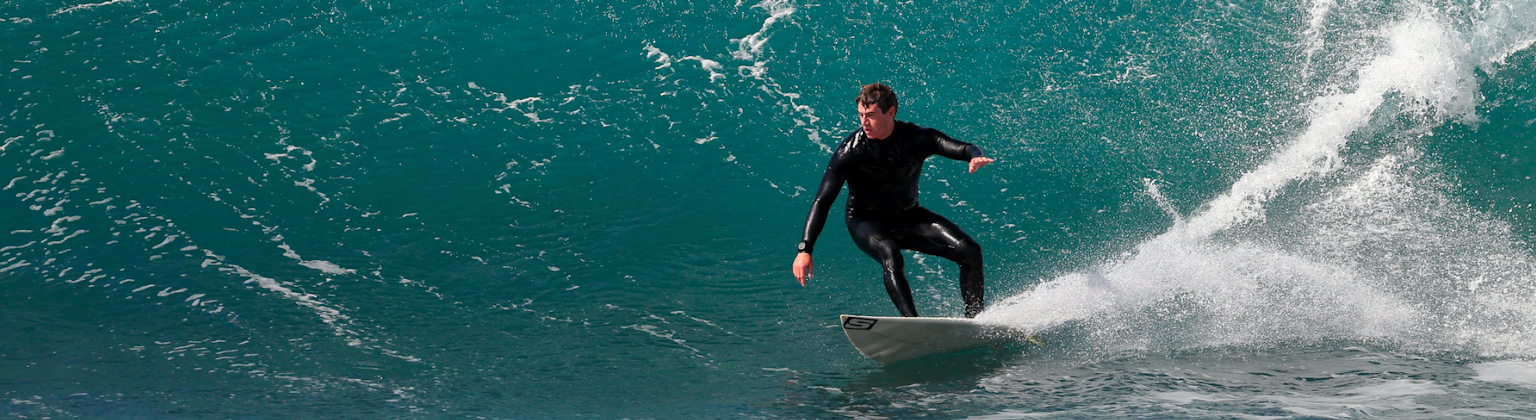 Photo taken of man in wetsuit surfing a wave, taken by Ed Dunens - https://flic.kr/p/D9PdPK