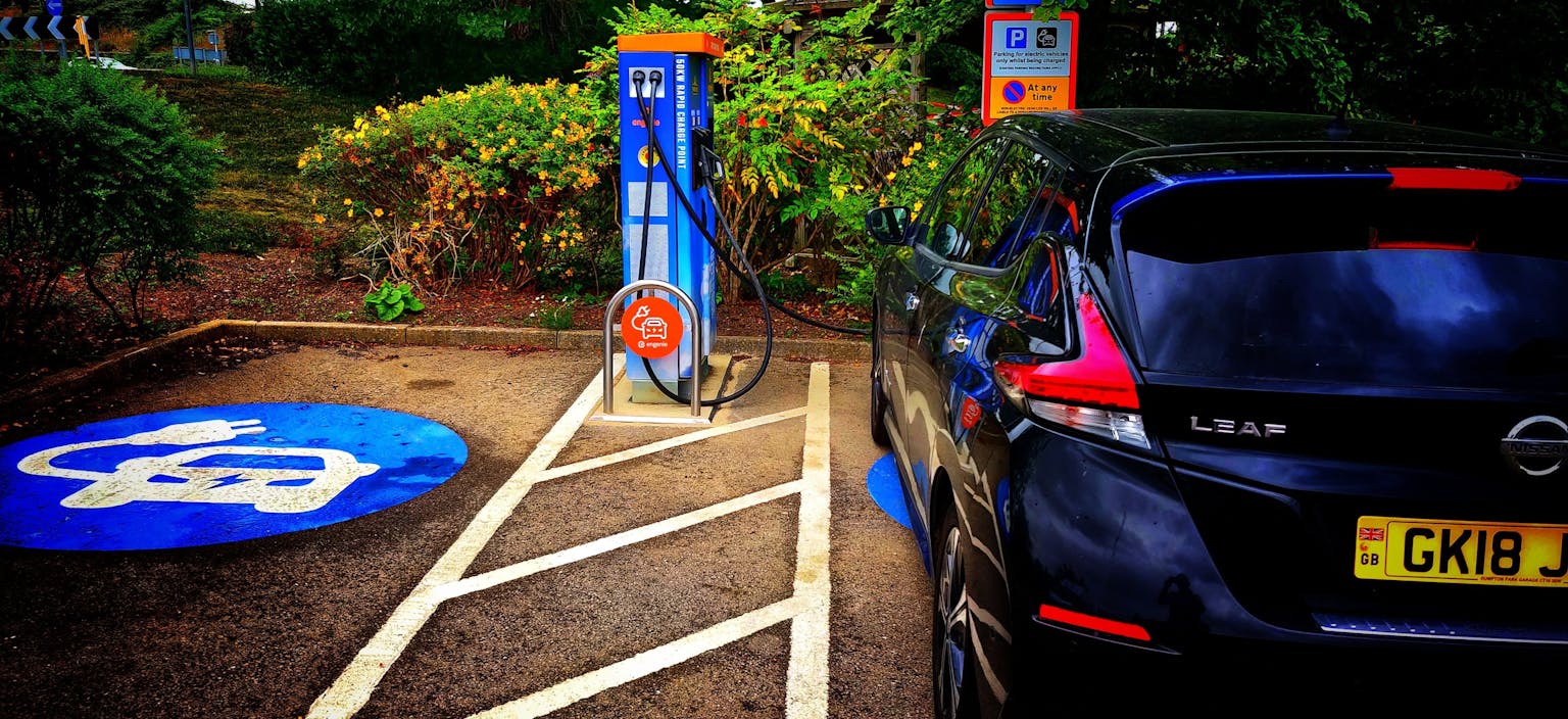 Image shows electric car charging at an osprey charging point