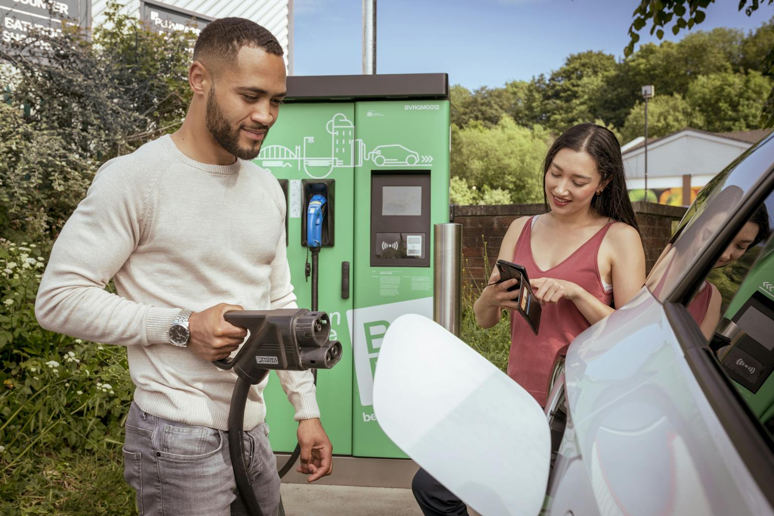 man and woman using a be.ev charging station